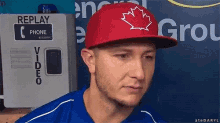 a man wearing a red hat with a canadian maple leaf on it