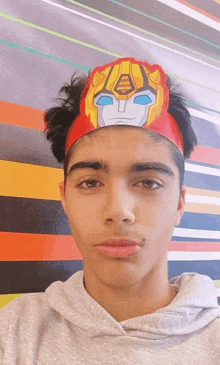 a young man wearing a paper transformer headband