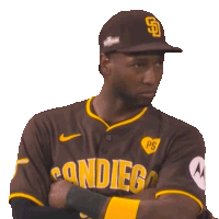 a san diego baseball player stands with his arms crossed and his eyes closed
