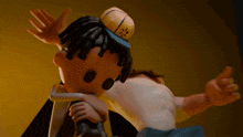 a cartoon character wearing a yellow hat with a sun on it is hugging another cartoon character