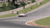 a race car is going down a track with chevrolet signs behind it