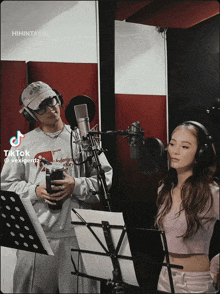 a man and a woman singing into microphones with a tiktok watermark on the bottom