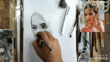 a person is drawing a woman 's face with a brush and the words made in animotica on the bottom