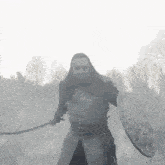 a man in armor is holding a sword and a shield .