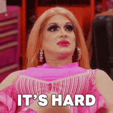 a drag queen says it 's hard while wearing a pink top