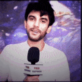 a man is holding a microphone that says viral television television