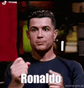 a man in a black shirt is giving a thumbs up and the word ronaldo is on the screen