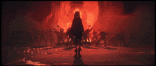 a woman stands in front of a crowd of people in a dark room