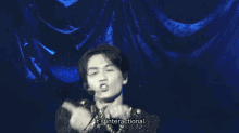 a man singing into a microphone with the words " it 's interactional " below him