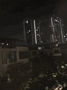 a city at night with a lot of tall buildings lit up
