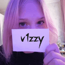 a girl with pink hair is holding a sign that says vizzy