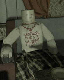 a doll with a sweater that says world 's best mom on it