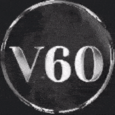 a silver circle with the word v60 written inside of it on a black background .