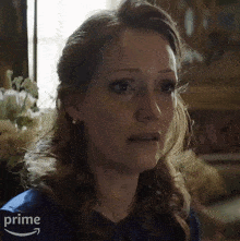 a close up of a woman 's face with a prime logo in the corner