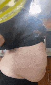 a woman with a very large belly is wearing a t-shirt that says ' sho ' on it