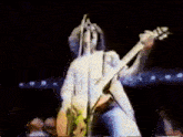 a man is singing into a microphone while playing a guitar