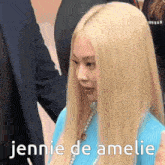 a woman with long blonde hair is wearing a blue sweater and pearls and says jennie de amelie .