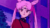 a girl with pink hair is wearing a red shirt and black earrings
