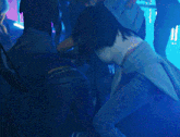 a blurry picture of a woman dancing in a room with a blue light behind her