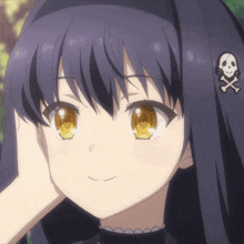 a close up of a girl with a skull and crossbones on her hair
