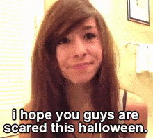 a girl with long brown hair is smiling and says i hope you guys are scared this halloween