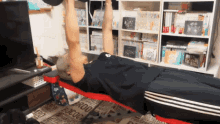 a man is lifting a dumbbell on a bench in a room with a rug that says boocock