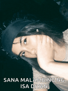 a woman covering her face with her hand and the words sana malambing ng isa diyan below her