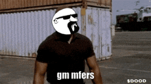 a man with a beard and sunglasses says " gm mfers " in a parking lot