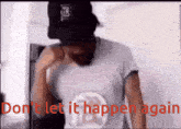 a man wearing a hat and a shirt that says ' do n't let it happen again ' on it
