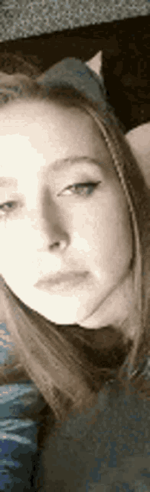 a close up of a girl 's face with a cat ear headband on .