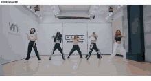 a group of women are dancing in front of a sign that says wine entertainment