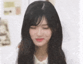 a woman with long black hair and bangs is making a funny face .