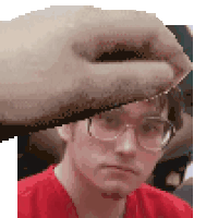 a pixel art of a man wearing glasses and a red shirt being touched by a hand .