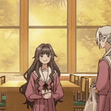 two anime girls are standing next to each other in front of a window in a room .
