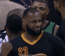 a man with a beard wears a jersey with the number 23 on it