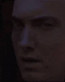 a close up of a man 's face in the dark