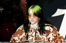 a woman with green hair is speaking into a microphone and says but that fool was wrong ..