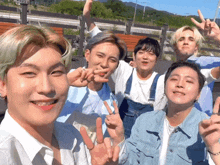 a group of young men are posing for a picture with their hands in the air