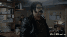 a man with glasses and a mustache is standing in front of a bar with the hashtag #iduh #showtime at the bottom