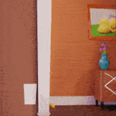 a vase of flowers sits on a dresser next to a picture of a duck