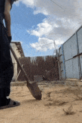 a man is digging with a shovel in a dirt field