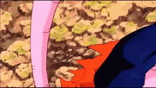 a close up of a cartoon character 's legs with a blurred background of rocks and plants