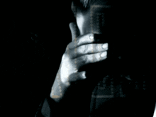 a close up of a person 's face with their hands on their chin
