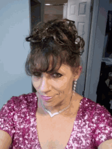 a woman wearing a necklace and earrings is smiling for the camera