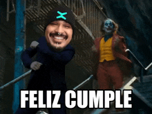 a man with a x on his hat is dancing next to a clown with the words feliz cumple written on the bottom