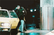 a man is carrying a woman into a taxi cab