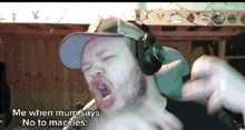 a man wearing headphones and a hat says me when mum says no to maccles