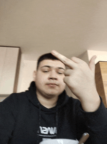a man wearing a black hoodie with nasa on it