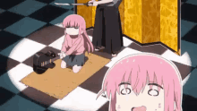 a girl with pink hair is kneeling down on a checkered floor while a man holds a sword .