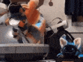 a stuffed animal is sitting on top of a table next to a computer .
